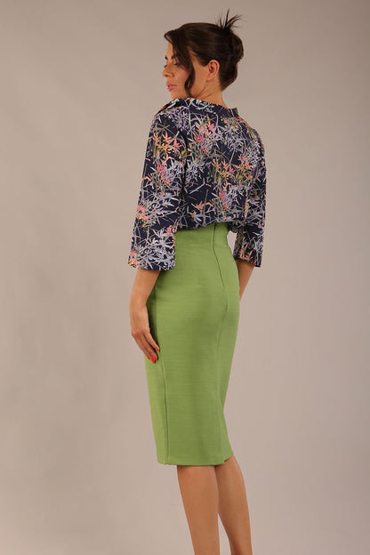 brunette model wearing a diva catwalk seed elixir pencil knee length skirt in citrus green front 