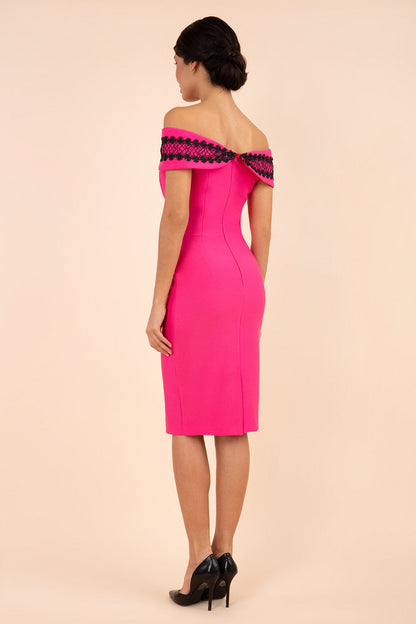 brunette model wearing diva catwalk kurumba pencil dress with bardot off shoulder neckline and lace detail across it in pink and black colour front