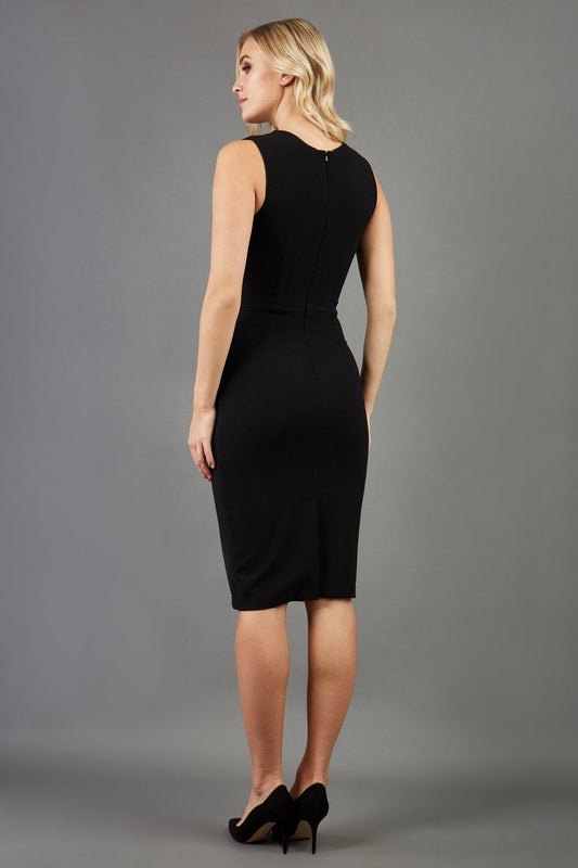 blonde model wearing diva catwalk pastiche pencil fitted sleeveless dress v-neckline with lace overlay in black front