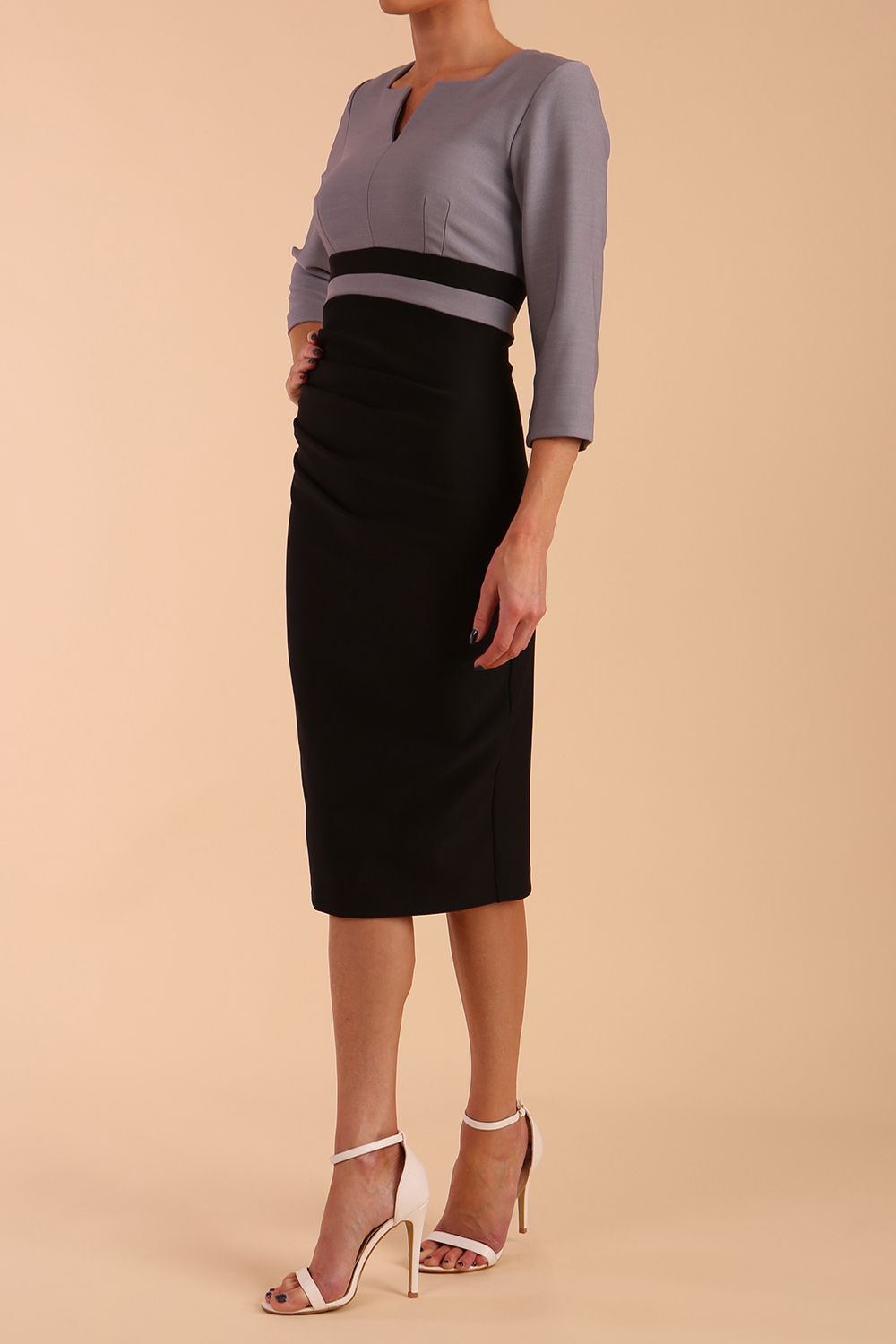 A model is wearing a three quarter sleeve colour block pencil dress by Diva Catwalk in Black and grey colour