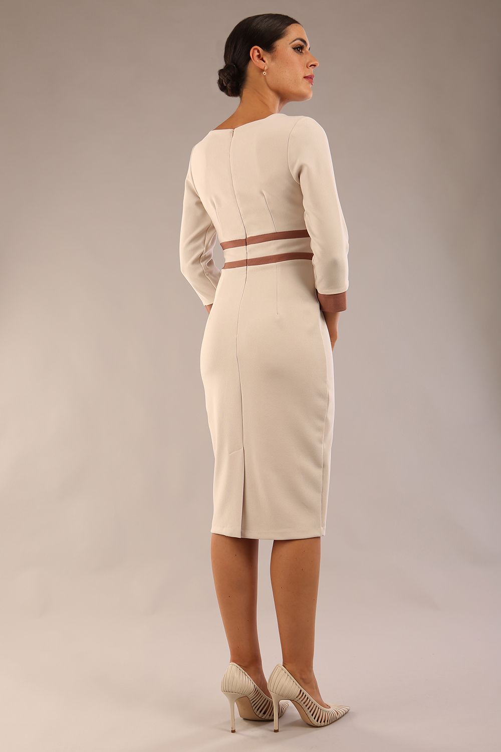 brunette model wearing Diva catwalk Paeonia dress square neckline with a vent in sandshell beige with Acorn Brown and sandshell beige stripes around the waist and three quarter sleeve with Acorn Brown contrast finish front close up