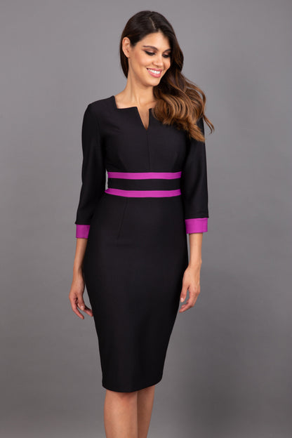 brunette model wearing Diva catwalk Paeonia dress square neckline with a vent in black with dawn purple and black stripes around the waist and three quarter sleeve with dawn purple contrast finish front