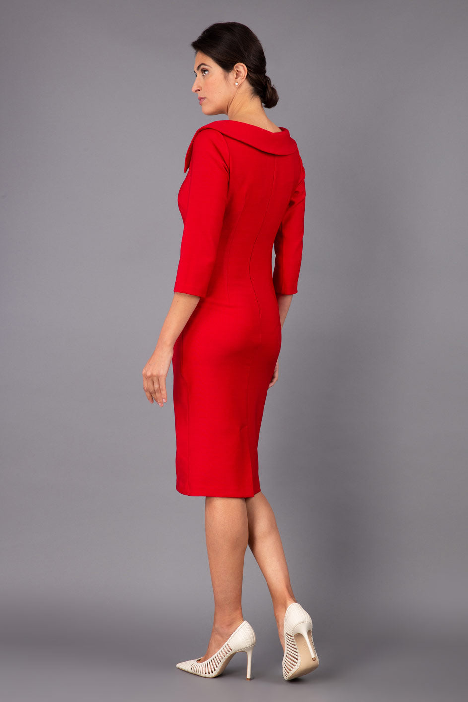 Model wearing Diva catwalk Opulus pencil dress in cardinal red with three quarter sleeve figure fitted front image