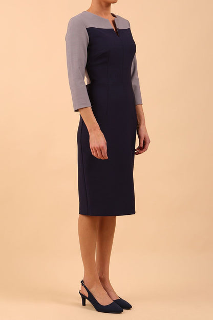 Model wearing Diva catwalk Katykat pencil figure fitted dress in navy blue and steel grey detail with three quarter sleeve front image