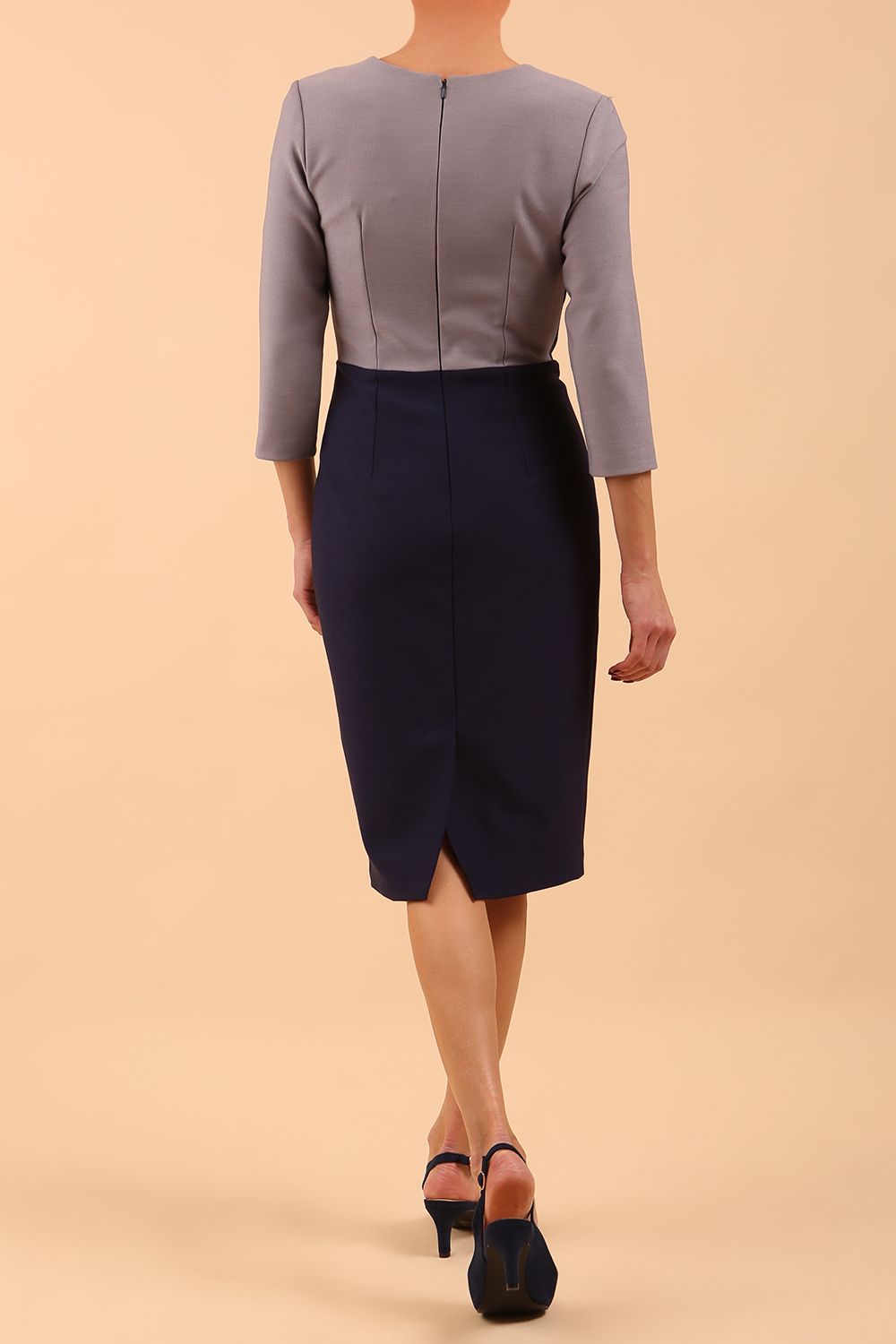 Model wearing Diva catwalk Katykat pencil figure fitted dress in navy blue and steel grey detail with three quarter sleeve front image