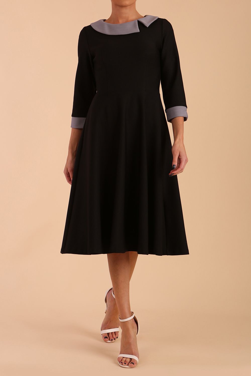 Model wearing Diva catwalk Coralia swing dress in black/ slate grey with three quarter sleeve figure fitted back image
