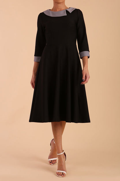 Model wearing Diva catwalk Coralia swing dress in black/ slate grey with three quarter sleeve figure fitted back image