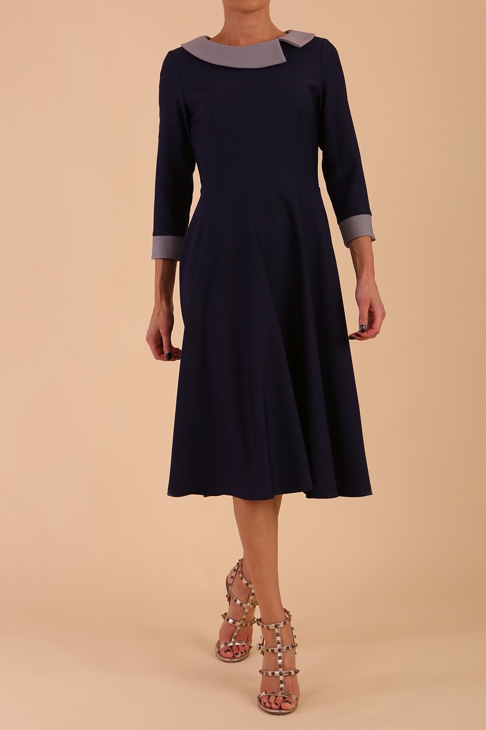 Model wearing Diva catwalk Coralia swing dress in navy / sky grey contrast with three quarter sleeve figure fitted front detail image