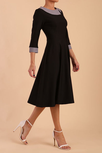 Model wearing Diva catwalk Coralia swing dress in black/ slate grey with three quarter sleeve figure fitted back image