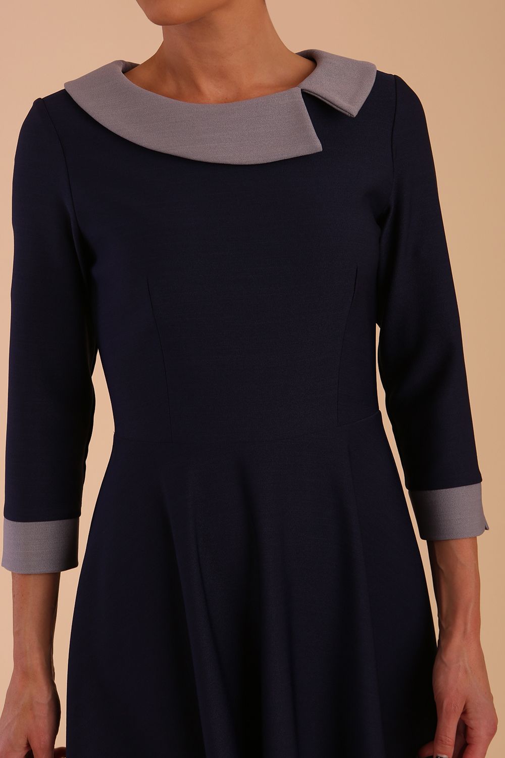 Model wearing Diva catwalk Coralia swing dress in navy / sky grey contrast with three quarter sleeve figure fitted front detail image