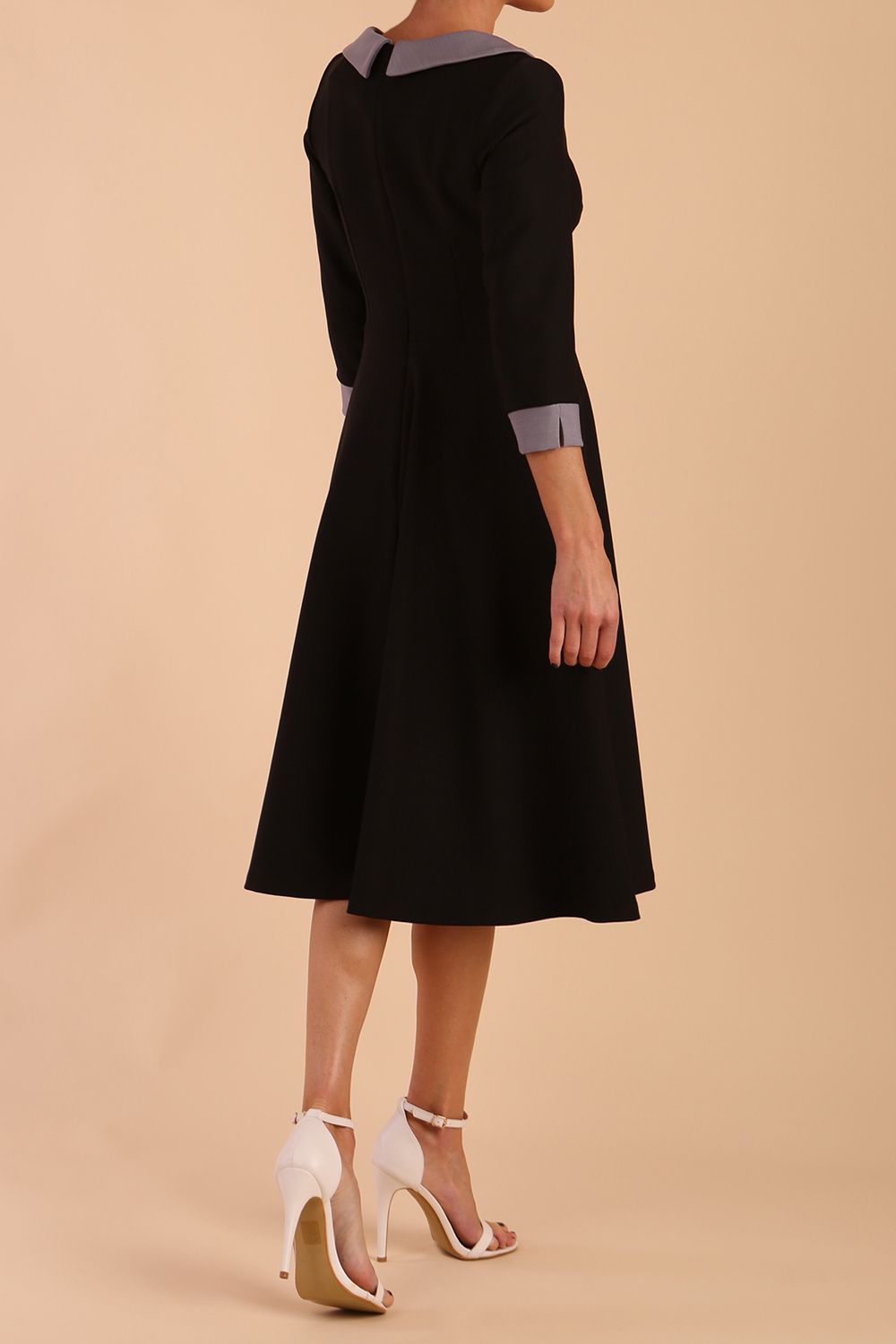 Model wearing Diva catwalk Coralia swing dress in black/ slate grey with three quarter sleeve figure fitted back image