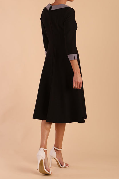 Model wearing Diva catwalk Coralia swing dress in black/ slate grey with three quarter sleeve figure fitted back image