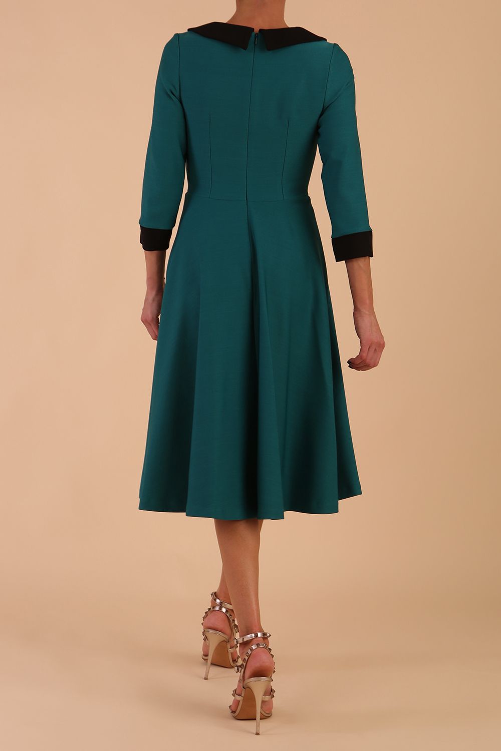Model wearing Diva catwalk Coralia swing dress in pacific green with three quarter sleeve figure fitted front image