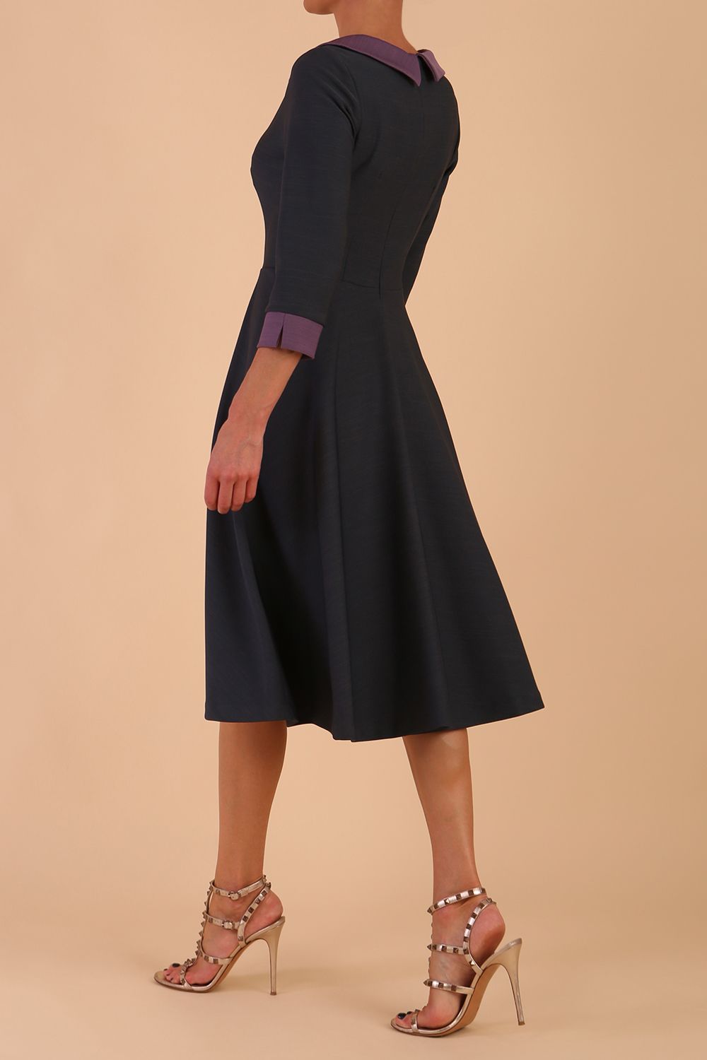Model wearing Diva catwalk Coralia swing dress in slate grey/ lilac with three quarter sleeve figure fitted front image