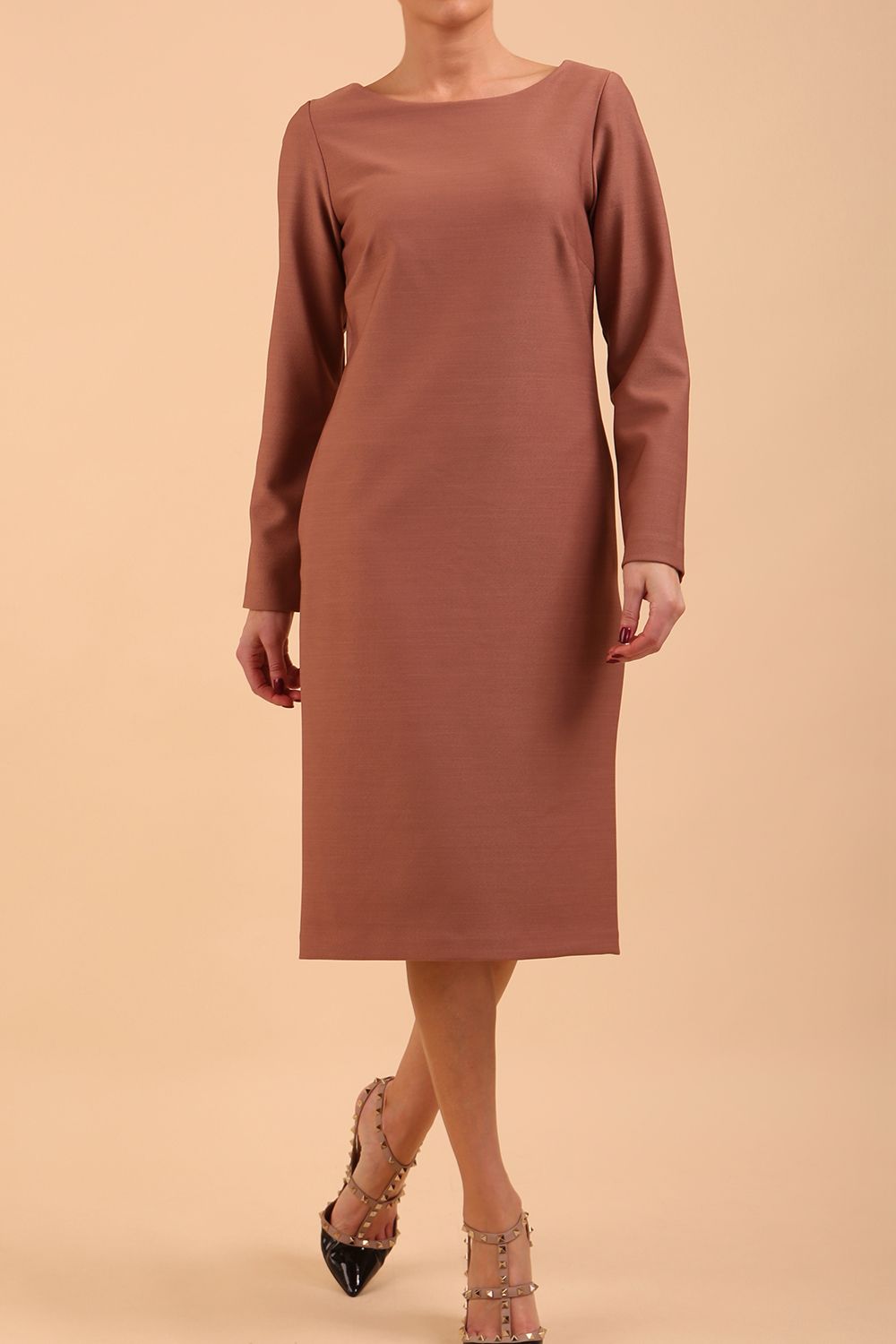 brunette model wearing diva catwalk cora white pencil dress with long sleeves and rounded neckline with pockets in colour acorn brown on side front