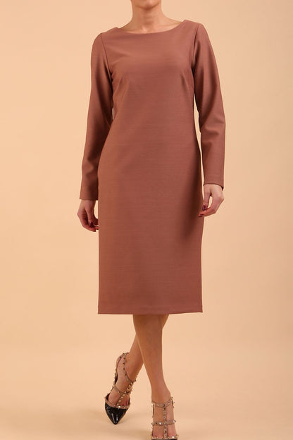 brunette model wearing diva catwalk cora white pencil dress with long sleeves and rounded neckline with pockets in colour acorn brown on side front