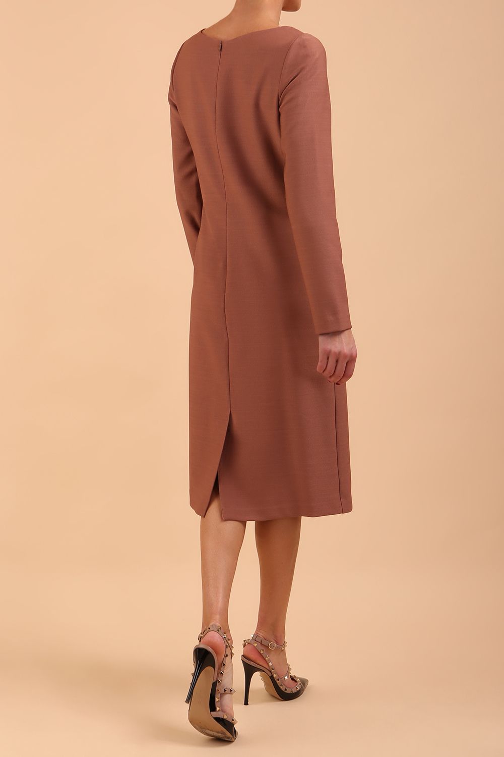 brunette model wearing diva catwalk cora white pencil dress with long sleeves and rounded neckline with pockets in colour acorn brown on side front