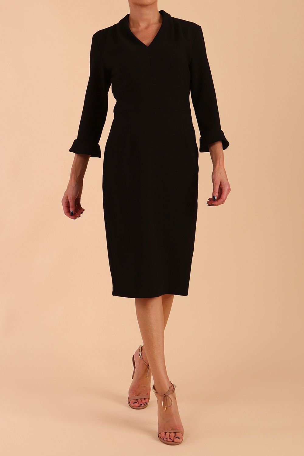 brunette model wearing diva catwalk adriana pencil dress with low v-neck and pleating around shoulders with three quarter sleeve detailed on end and wide waistband in black front