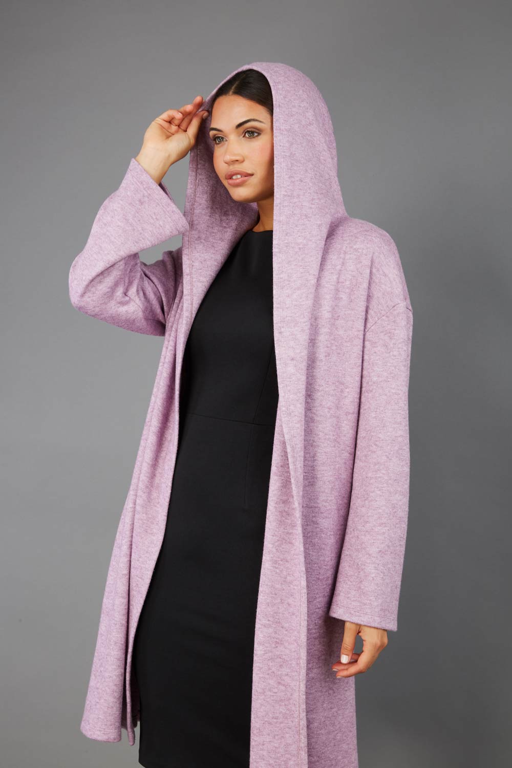 brunette model wearing diva catwalk hooded coat with long sleeves in soft cosy cashmere in pink front