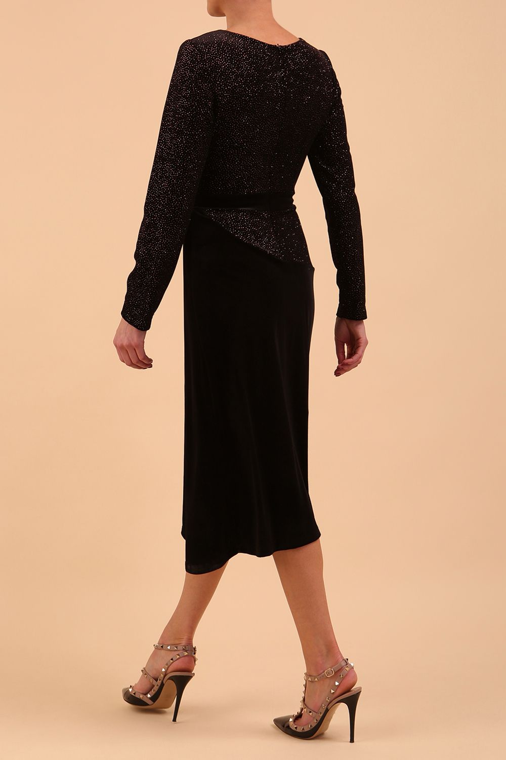Brunette Model wearing assymetric glitter and black velvet long sleeve dress front image