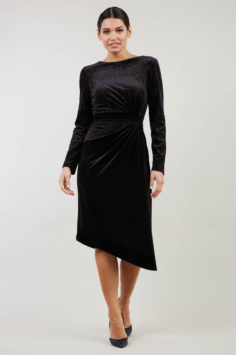 Brunette Model wearing assymetric glitter and black velvet long sleeve dress front image
