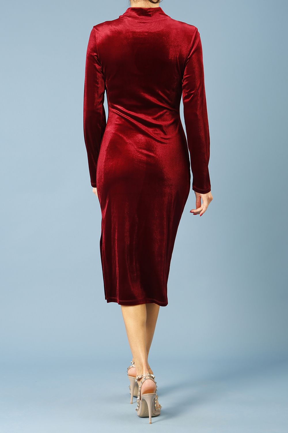 brunette model wearing diva catwalk clipper pencil skirt dress velvet sleeved style with a keyhole detail and high neck and split on a side of the skirt in colour burgundy front