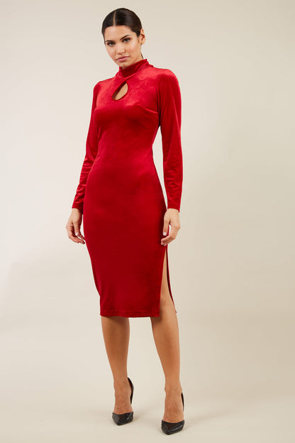 brunette model wearing diva catwalk clipper pencil skirt dress velvet sleeved style with a keyhole detail and high neck and split on a side of the skirt in colour red front