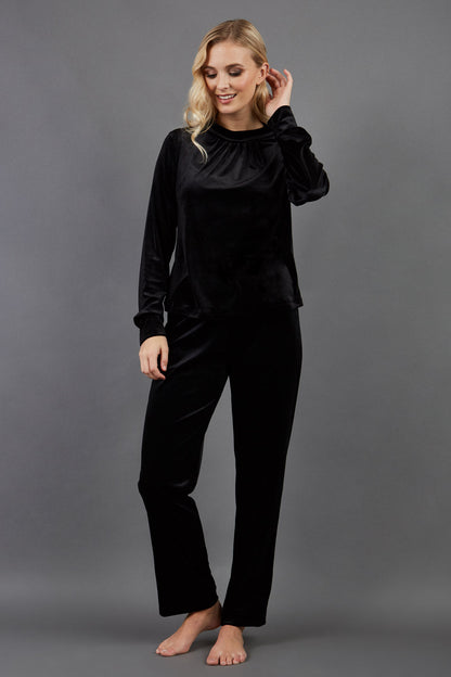 blonde model is wearing diva catwalk allium velvet sleeved high neck top in colour black front
