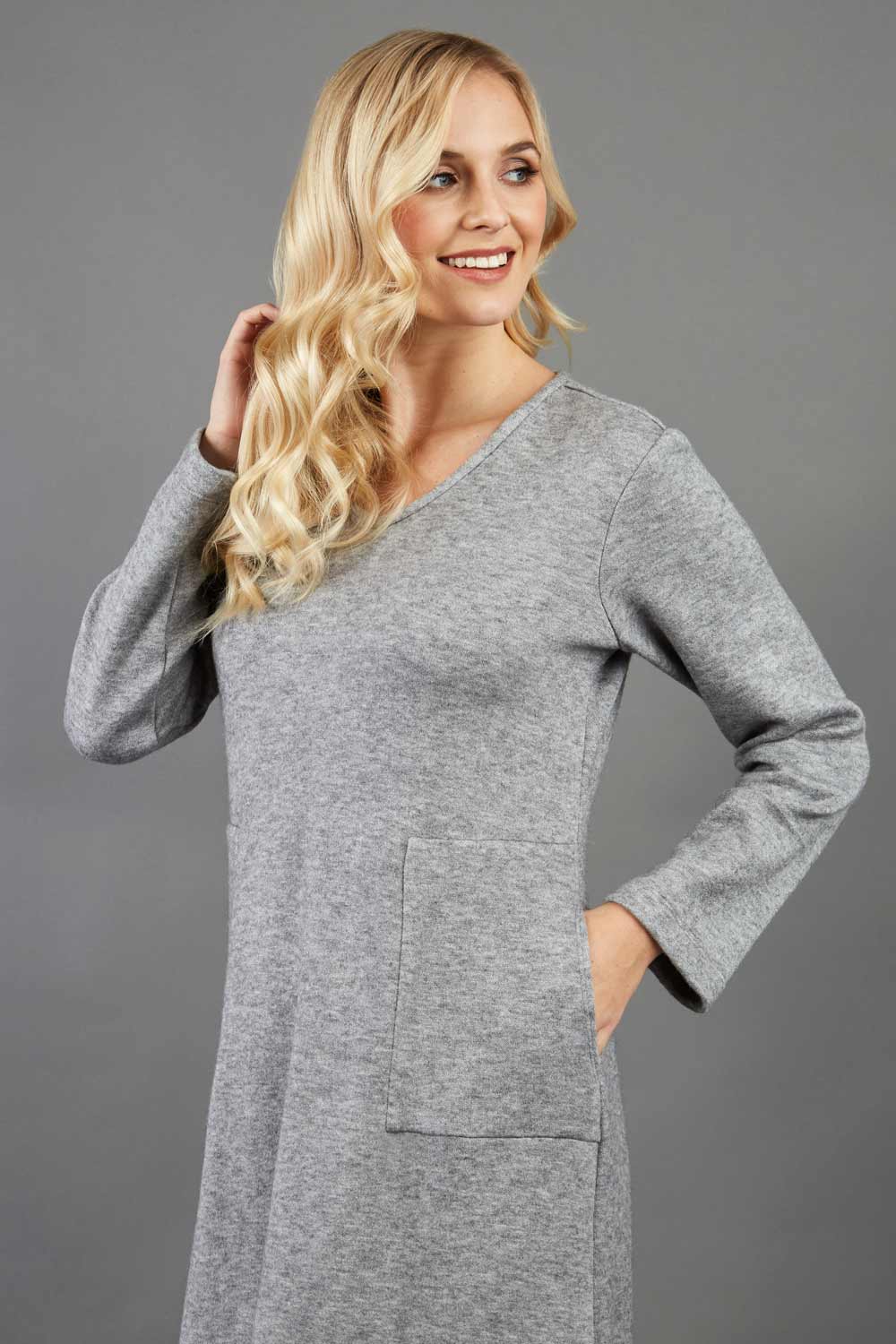 blonde model wearing diva catwalk irena cosy sleeved knee length dress with pockets and v-neckline in soft fabric grey front