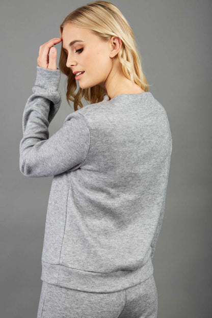 blonde model wearing diva catwalk hudson top with long sleeves and boat neckline in very soft cosy cashmere fabric in grey colour front with aria joggers matching the top front