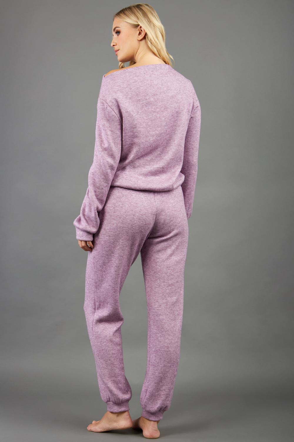 blonde model wearing diva catwalk hudson top with long sleeves and boat neckline in very soft cosy cashmere fabric in pink colour front with aria joggers matching the top front