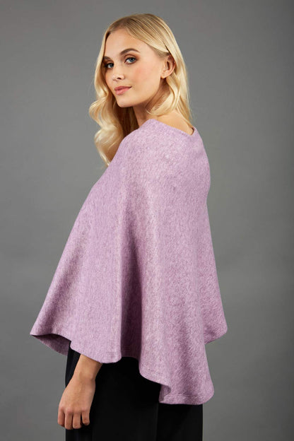 blonde model wearing diva catwalk rosalia poncho made in very cosy soft cashmere fabric in pale pink front
