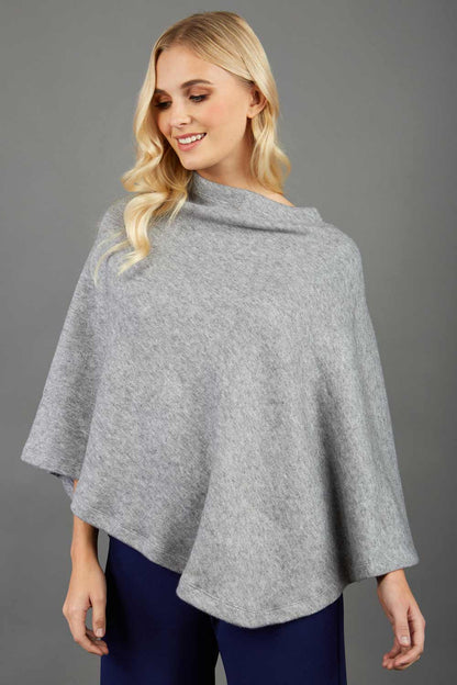 blonde model wearing diva catwalk rosalia poncho made in very cosy soft cashmere fabric in flint grey front