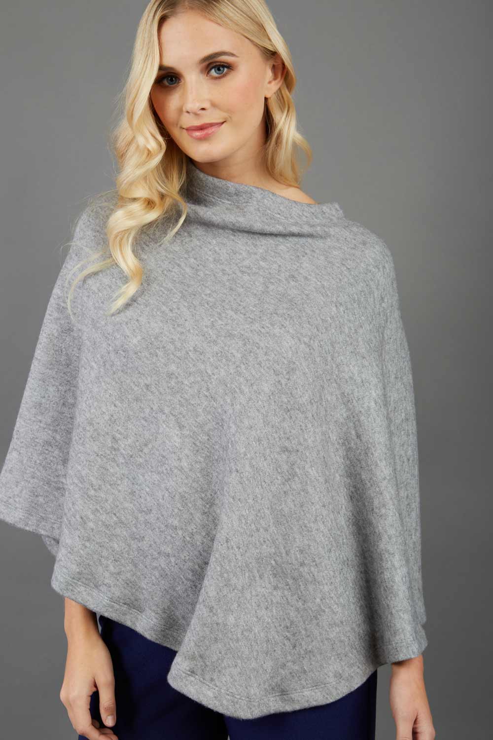 blonde model wearing diva catwalk rosalia poncho made in very cosy soft cashmere fabric in flint grey front