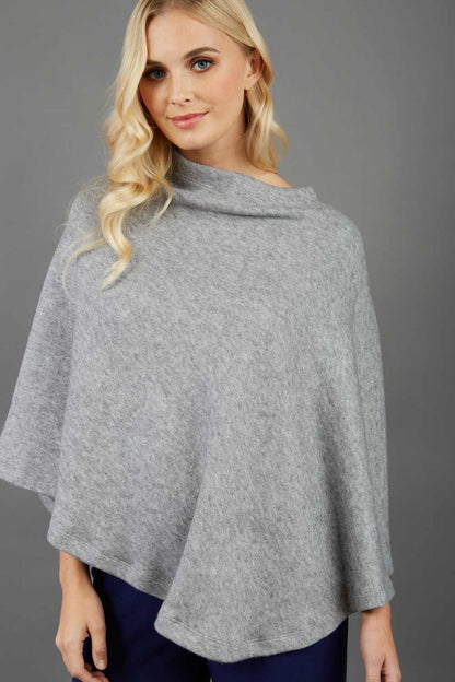 blonde model wearing diva catwalk rosalia poncho made in very cosy soft cashmere fabric in flint grey front