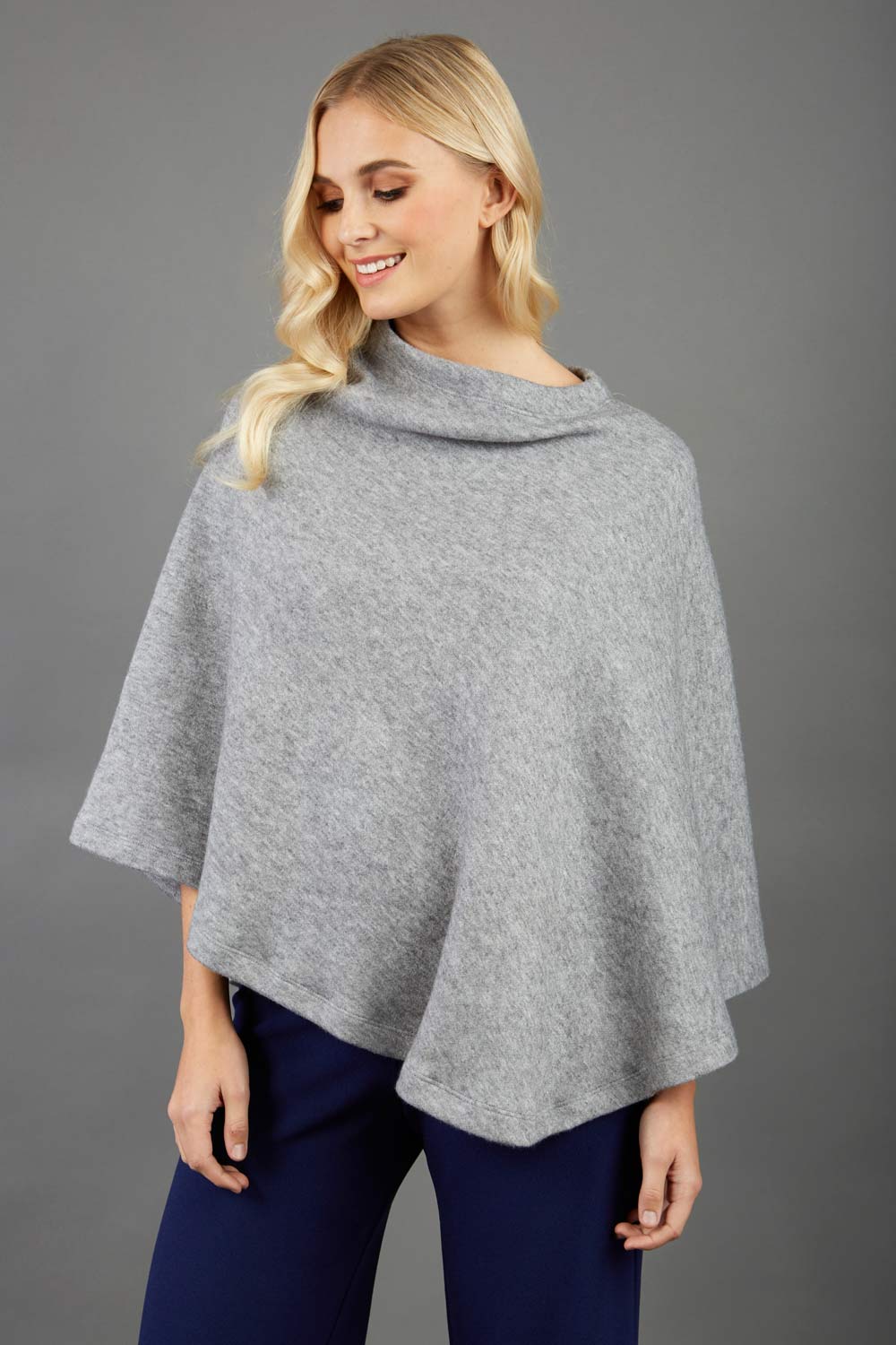 blonde model wearing diva catwalk rosalia poncho made in very cosy soft cashmere fabric in flint grey front