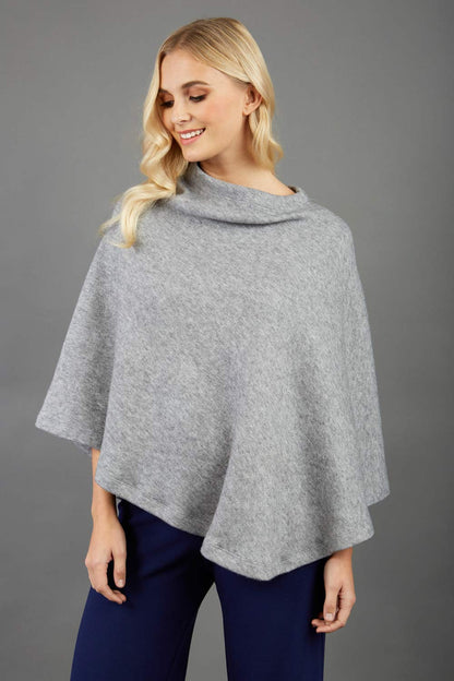 blonde model wearing diva catwalk rosalia poncho made in very cosy soft cashmere fabric in flint grey front
