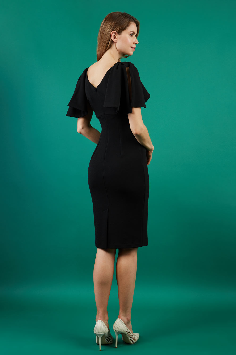 brunette model is wearing diva catwalk hermione pencil dress with tie shoulder details and empire waistline in black front