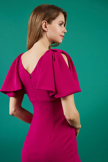 brunette model is wearing diva catwalk hermione pencil dress with tie shoulder details and empire waistline in magenta haze front