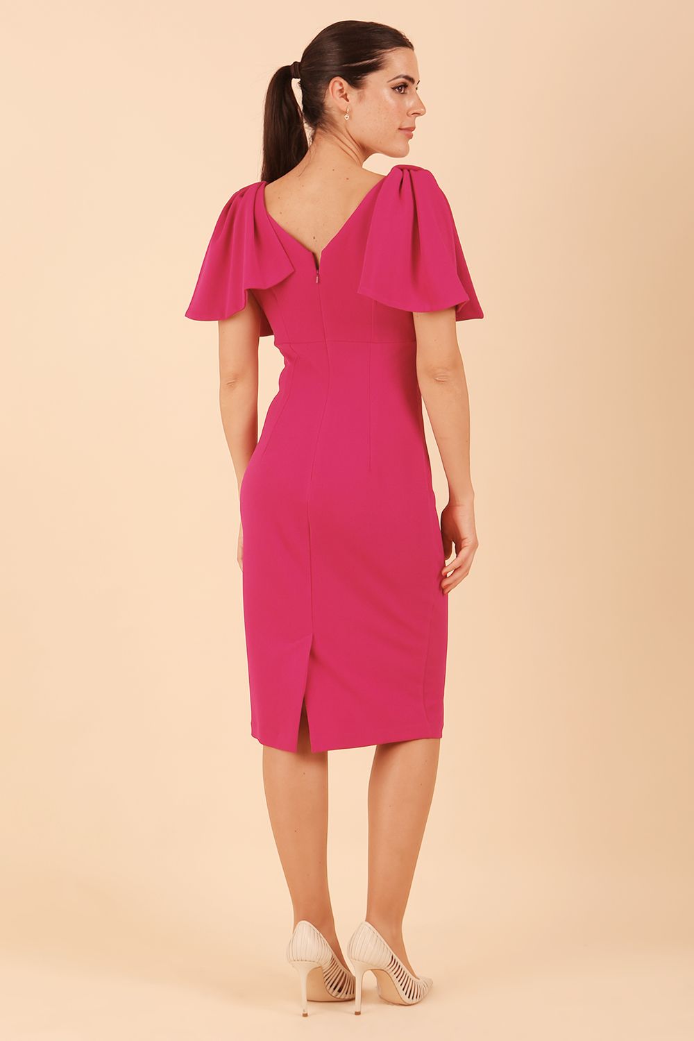 brunette model is wearing diva catwalk hermione pencil dress with tie shoulder details and empire waistline in magenta haze front