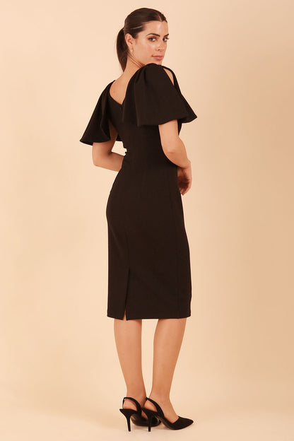 brunette model is wearing diva catwalk hermione pencil dress with tie shoulder details and empire waistline in black front