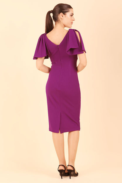 brunette model is wearing diva catwalk hermione pencil dress with tie shoulder details and empire waistline in Deep Purple front