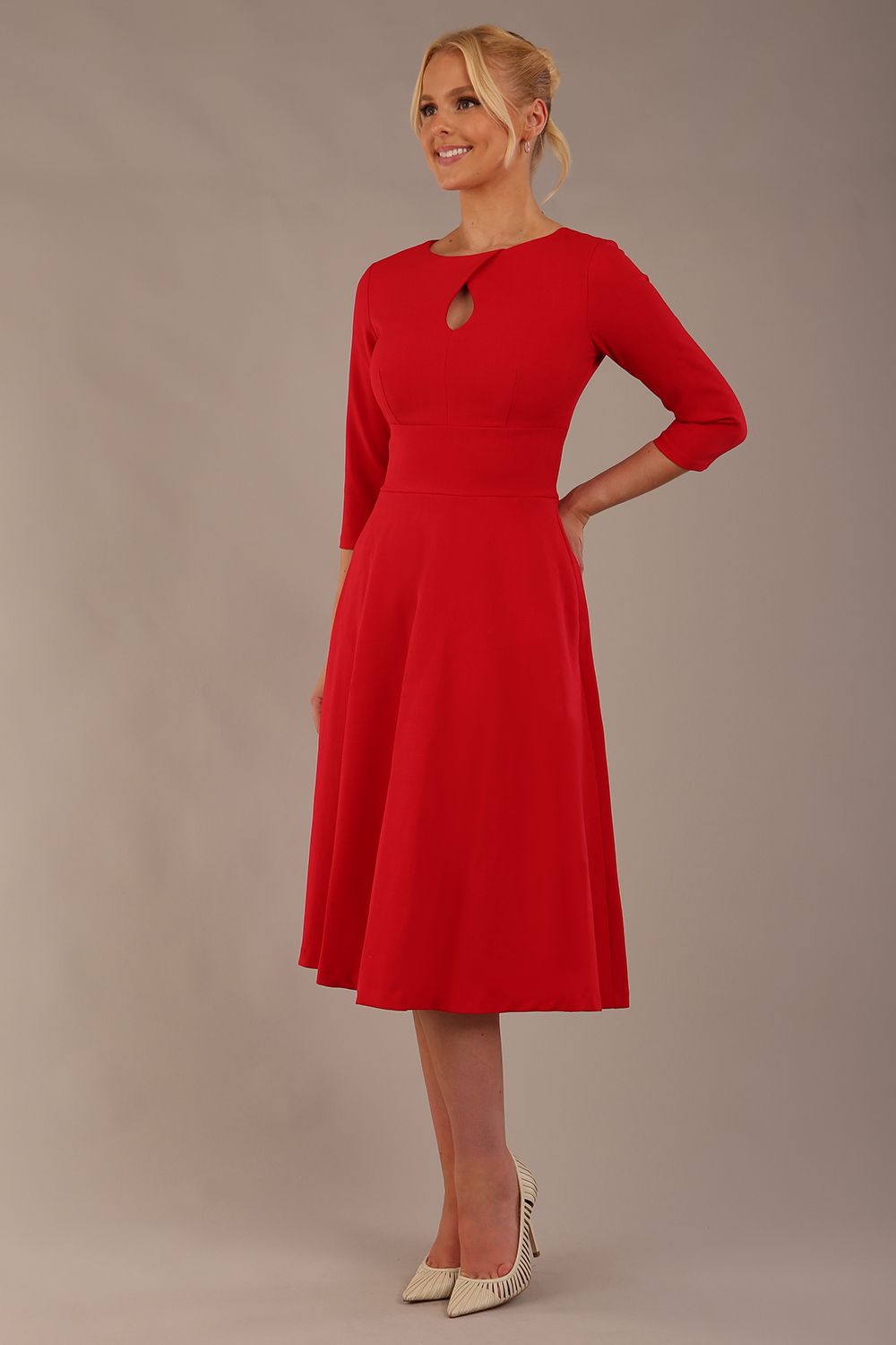 Brunette model is wearing diva catwalk casares swing dress with a keyhole neckline three quarter sleeve dress with pocket detail in red front (Scarlet Red)
