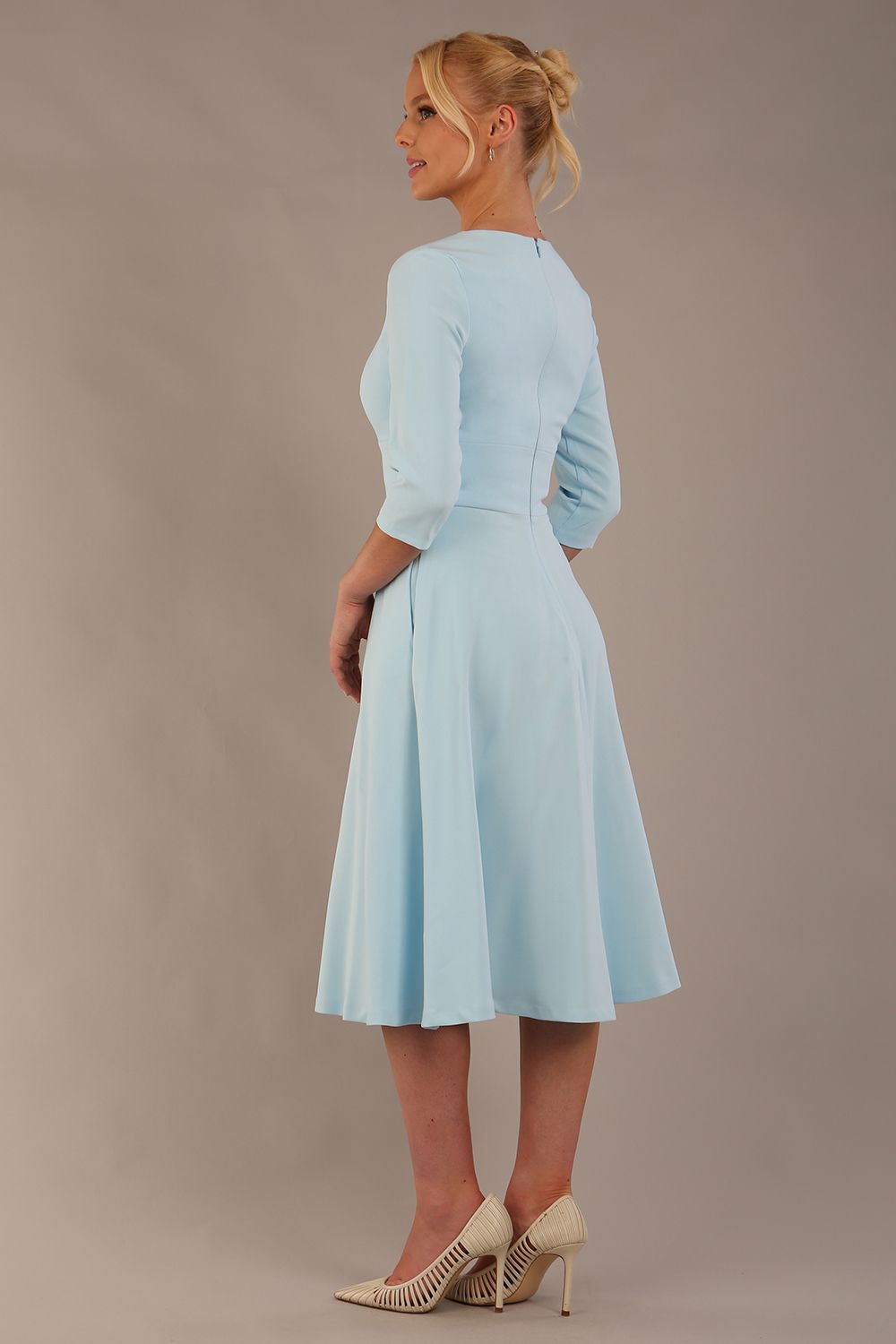 Brunette model is wearing diva catwalk casares swing dress with a keyhole neckline three quarter sleeve dress with pocket detail in sky blue front (Sky Blue)