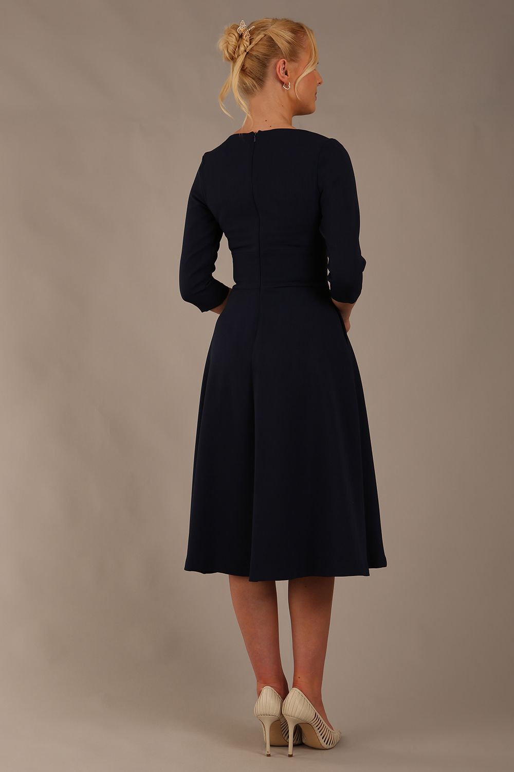  model is wearing diva catwalk casares swing dress with a keyhole neckline three quarter sleeve dress with pocket detail in navy blue front (Navy Blue)