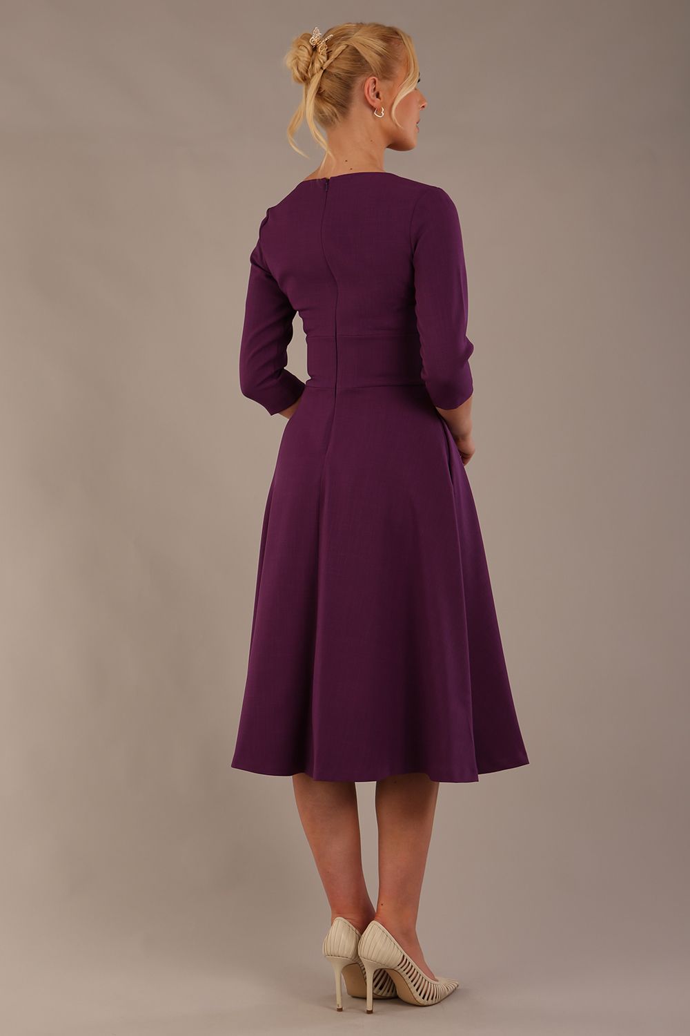 model is wearing diva catwalk casares swing dress with a keyhole neckline three quarter sleeve dress with pocket detail in imperial purple side front (Imperial Purple)