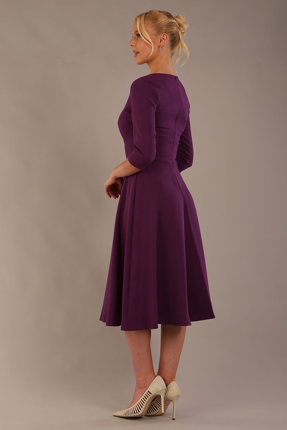 model is wearing diva catwalk casares swing dress with a keyhole neckline three quarter sleeve dress with pocket detail in imperial purple side front (Imperial Purple)