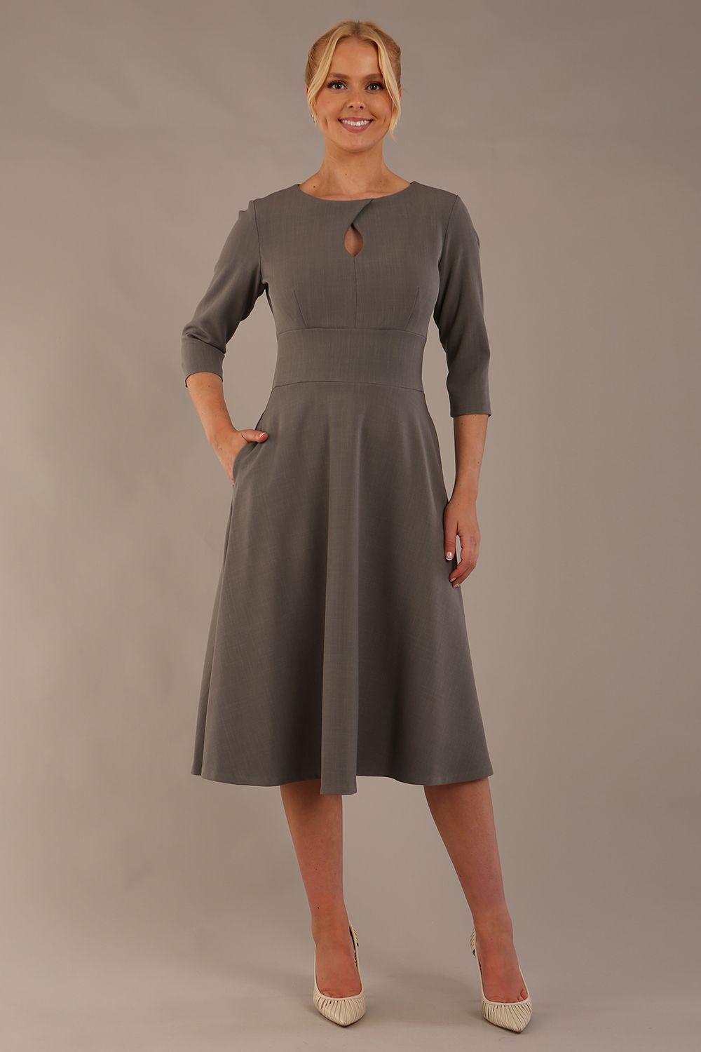 model is wearing diva catwalk casares swing dress with a keyhole neckline three quarter sleeve dress with pocket detail in Castlerock Grey  front (Castlerock Grey)