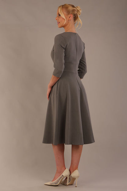 model is wearing diva catwalk casares swing dress with a keyhole neckline three quarter sleeve dress with pocket detail in Castlerock Grey  front (Castlerock Grey)