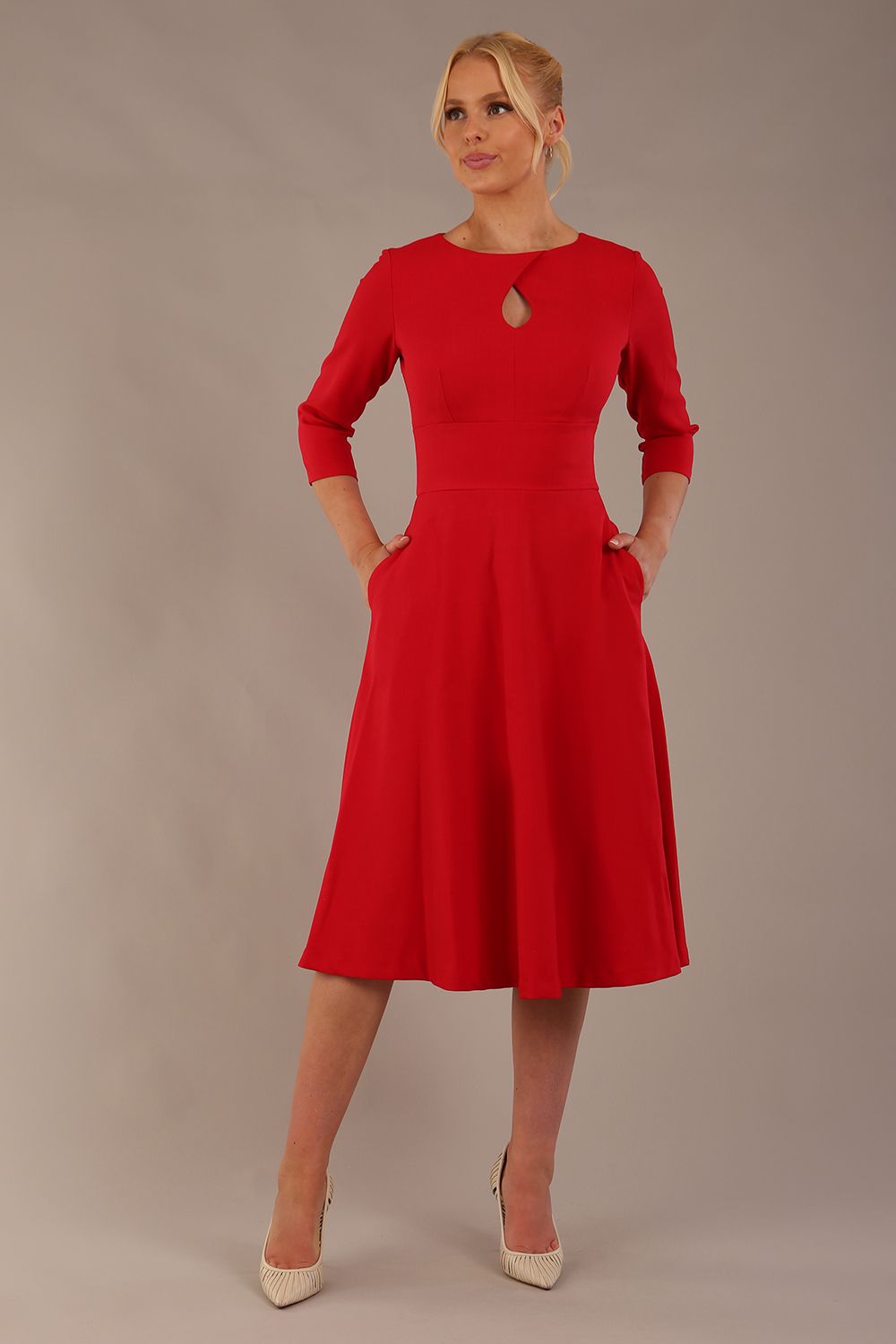 Brunette model is wearing diva catwalk casares swing dress with a keyhole neckline three quarter sleeve dress with pocket detail in red front (Scarlet Red)